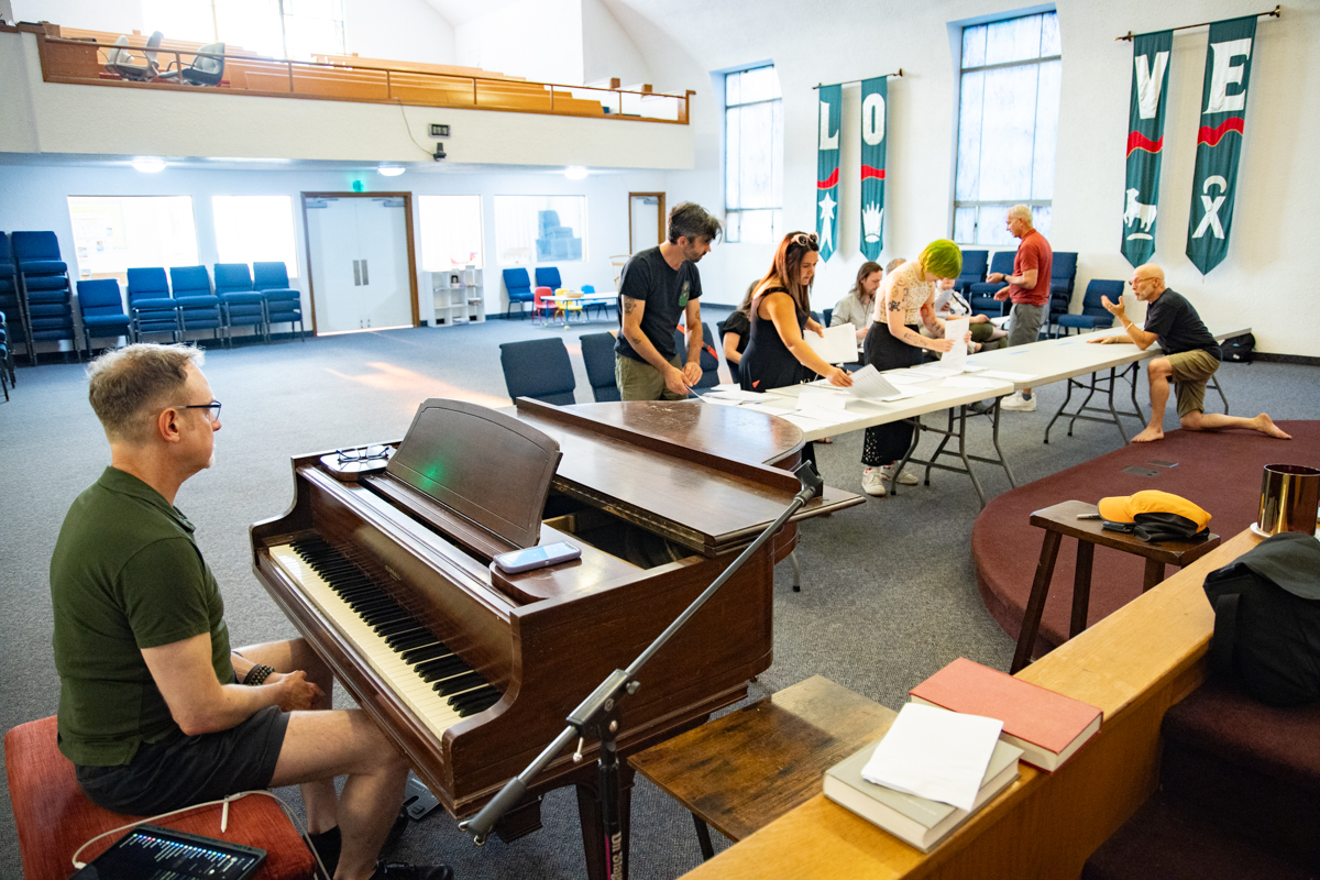 Music director Barney Stein (foreground) and the cast in rehearsal